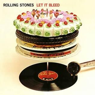 Let It Bleed album cover (Rolling Stones, 1969) — surreal sculptural stack: vinyl record, film canister, clock face, pizza, bicycle tyre and a Delia Smith cake with miniature band figurines on top, designed by Robert Brownjohn