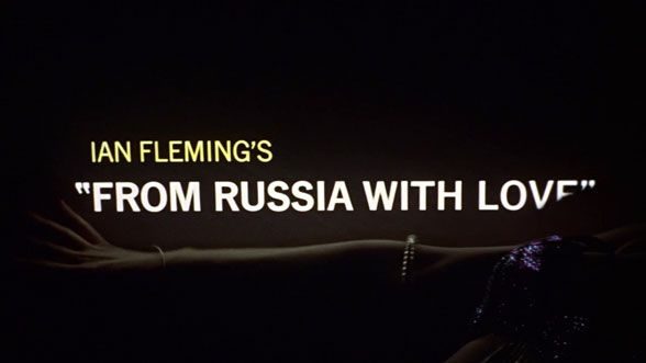 From Russia With Love (1963) title sequence still — title credits projected in coloured light across a dancer's body, designed by Robert Brownjohn