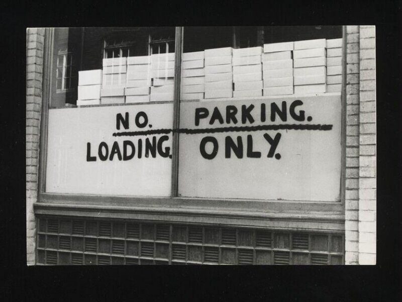 Street Level (1961) — gelatin silver print by Robert Brownjohn documenting London vernacular typography: a handpainted sign reading NO. PARKING. LOADING. ONLY.