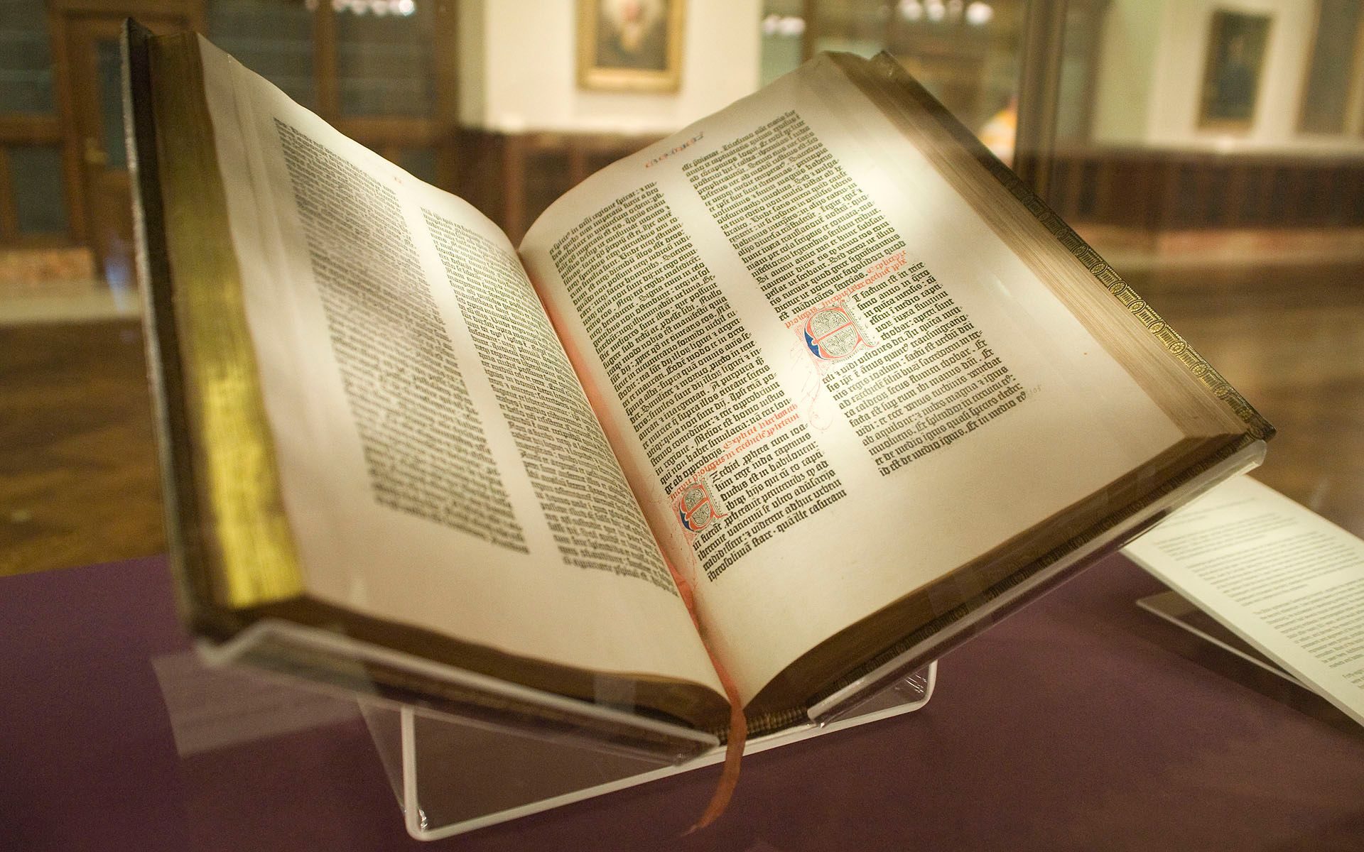 Open pages of the Gutenberg Bible, Lenox Copy, New York Public Library, showing two columns of dense Gothic type with rubricated initials