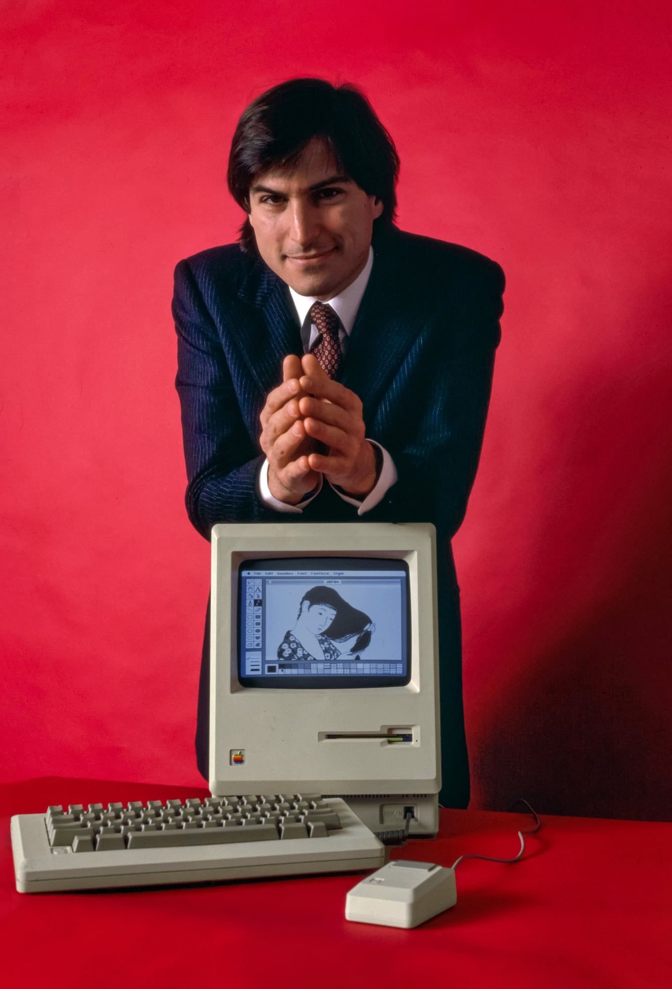 Steve Jobs holding the Macintosh computer, January 1984, photographed by Bernard Gotfryd